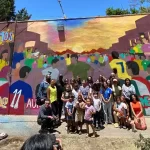 Artistas trabajando en murales Mundial 2026 Tijuana en una biblioteca pública